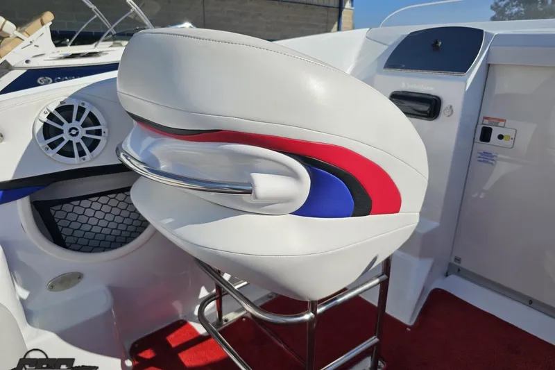 Slide: The Image of 2005 Baja 23 Outlaw boat interior with white seat, red and blue accents. - 53