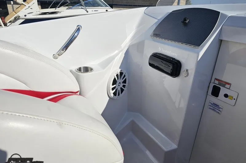 Slide: The Image of 2005 Baja 23 Outlaw boat interior with white seating and audio system. - 56