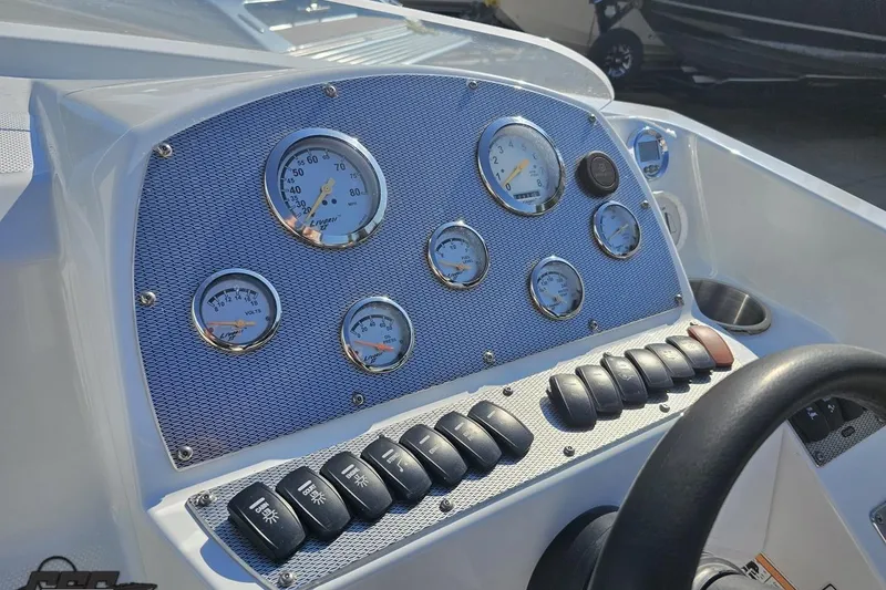 Slide: The Image of Dashboard of a 2005 Baja 23 Outlaw boat with gauges and controls. - 60