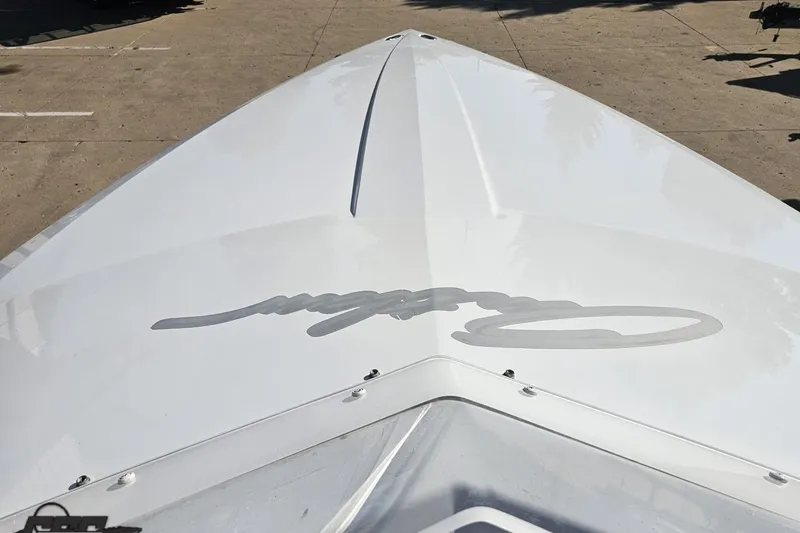 Slide: The Image of 2005 Baja 23 Outlaw boat bow with sleek white design and logo. - 61