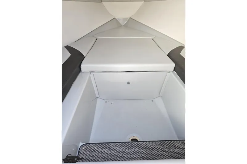 Slide: The Image of 2005 Baja 23 Outlaw boat interior with cushioned seating and storage compartment. - 65