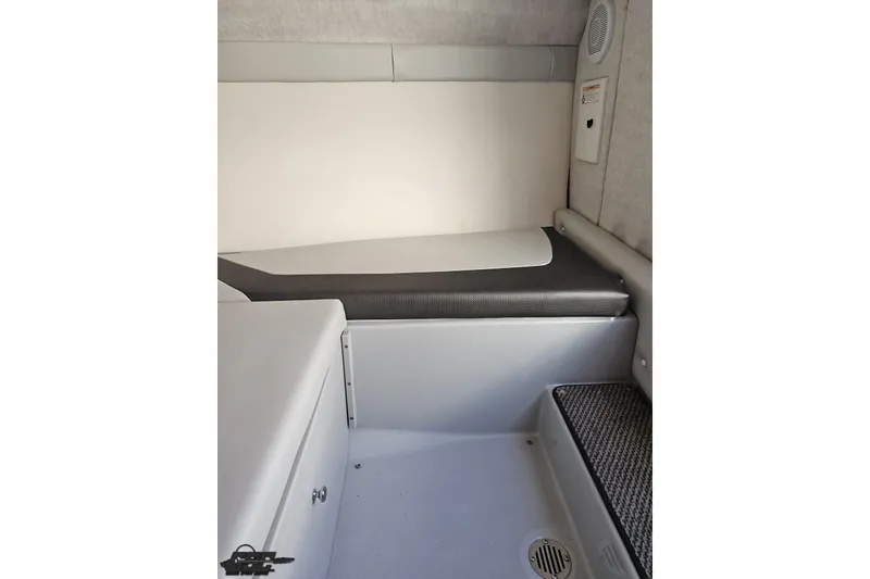 Slide: The Image of Interior cabin of a 2005 Baja 23 Outlaw boat, featuring seating and speaker. - 66