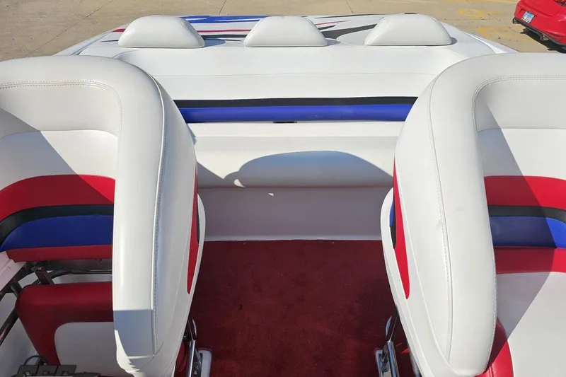 Slide: The Image of 2005 Baja 23 Outlaw boat interior with red, white, and blue seating. - 69