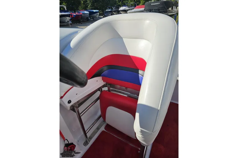 Slide: The Image of 2005 Baja 23 Outlaw boat seat with red, white, and blue upholstery. - 70