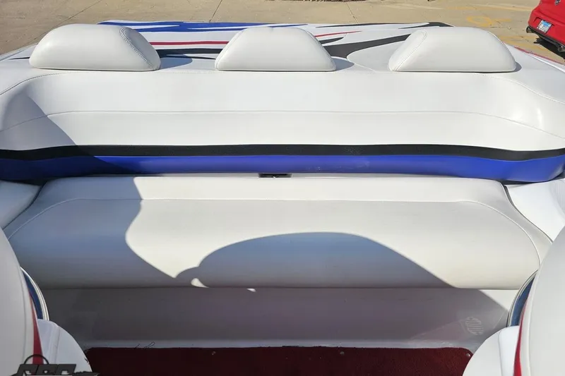Slide: The Image of 2005 Baja 23 Outlaw boat interior with white and blue seating. - 72