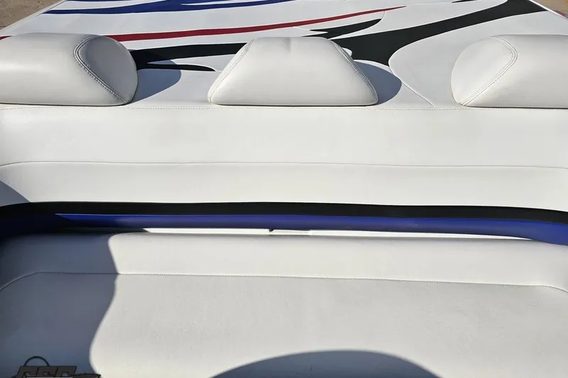 Slide: The Image of 2005 Baja 23 Outlaw boat interior with white leather seating and colorful design. - 73