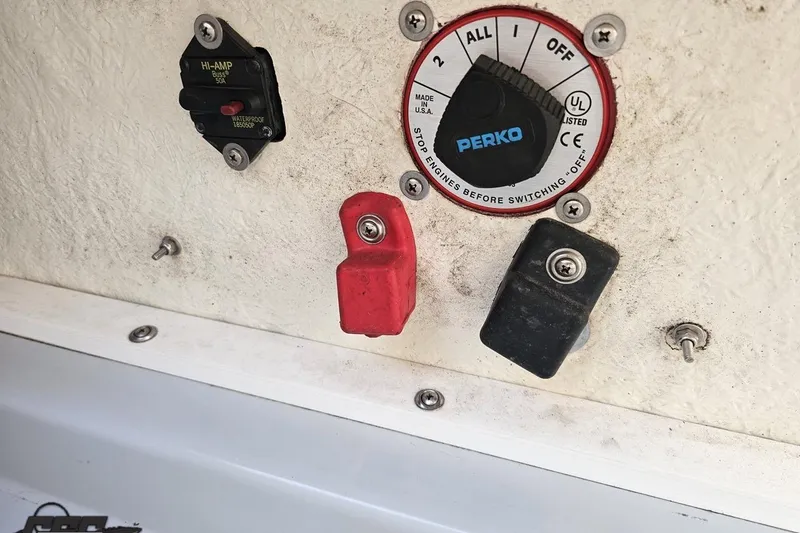 Slide: The Image of 2005 Baja 23 Outlaw boat battery switch and circuit breaker panel. - 76