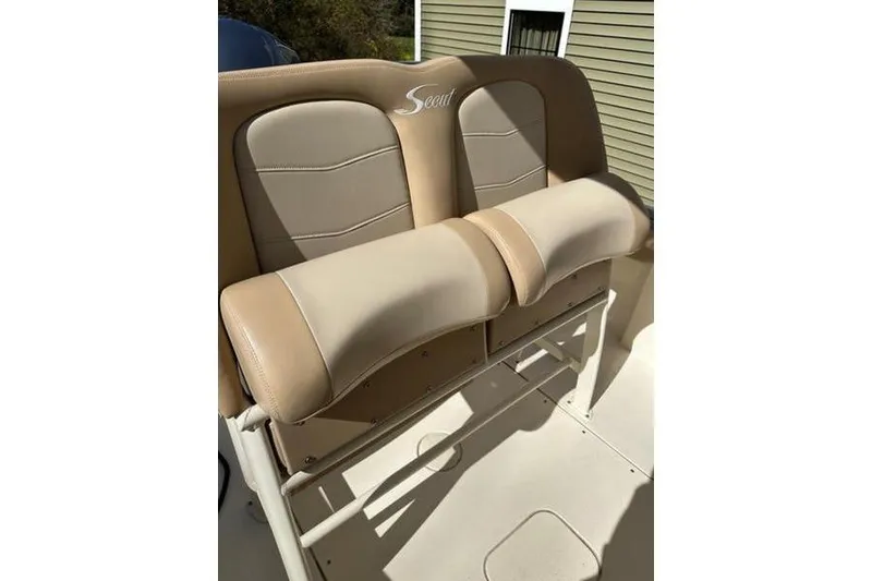 Slide: The Image of 2021 Scout 235 XSF boat seat with beige upholstery and logo detail. - 11