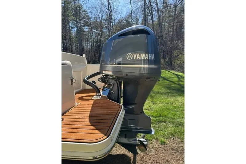 Slide: The Image of 2021 Scout 235 XSF boat with Yamaha outboard motor on wooden deck. - 12