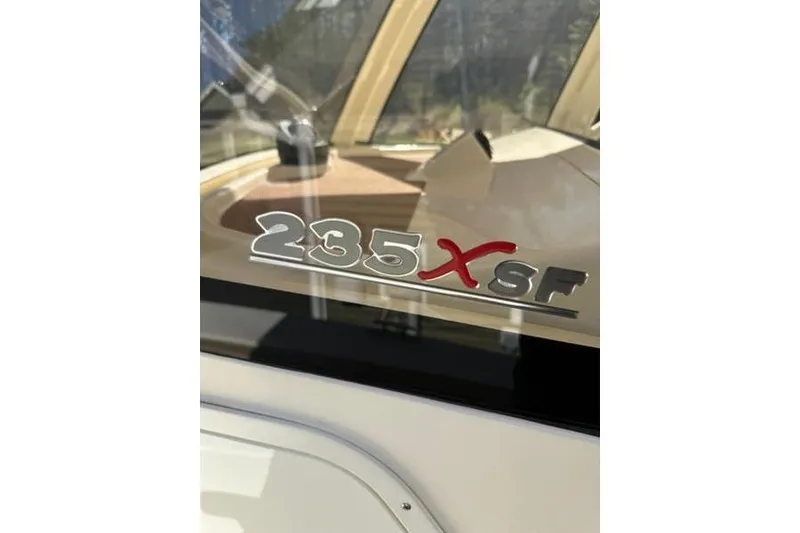 Slide: The Image of Close-up of 2021 Scout 235 XSF boat model emblem on glass surface. - 4