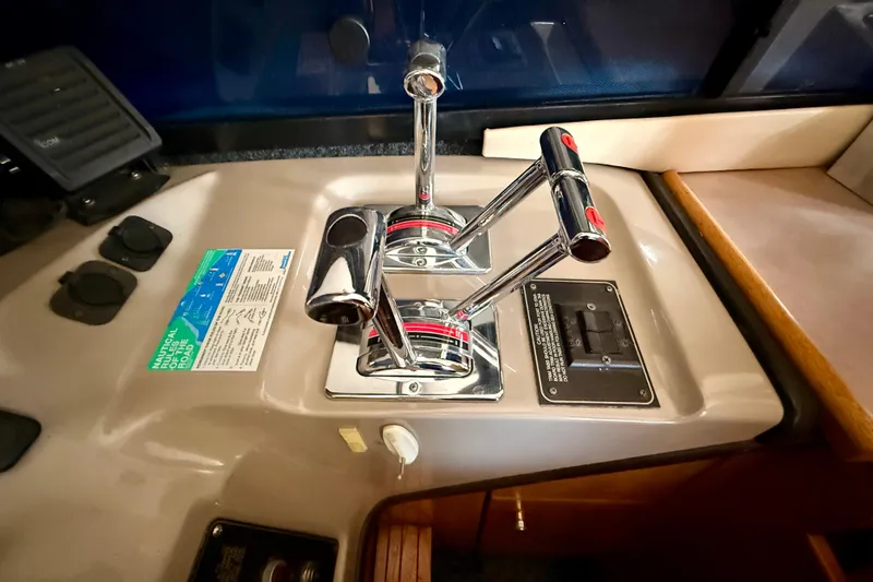Slide: The Image of 1998 Bayliner 3988 Command Bridge Motoryacht helm with steering wheel and control panel. - 11