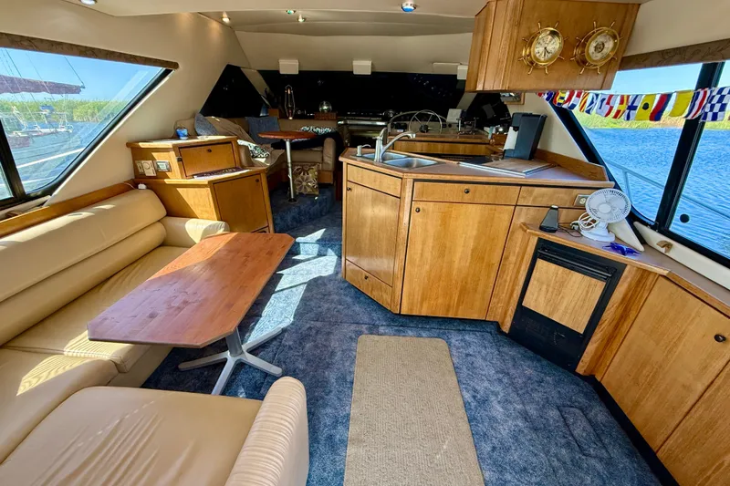 Slide: The Image of 1998 Bayliner 3988 Command Bridge Motoryacht helm with steering wheel and navigation controls. - 12