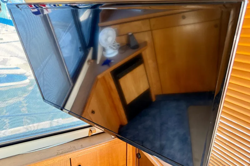 Slide: The Image of Luxurious interior of 1998 Bayliner 3988 Command Bridge Motoryacht with cozy seating and wooden table. - 18