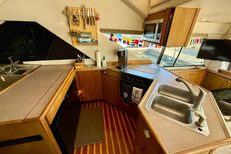 Slide: The Image of Interior of 1998 Bayliner 3988 Command Bridge Motoryacht with wooden cabinetry and nautical decor. - 21