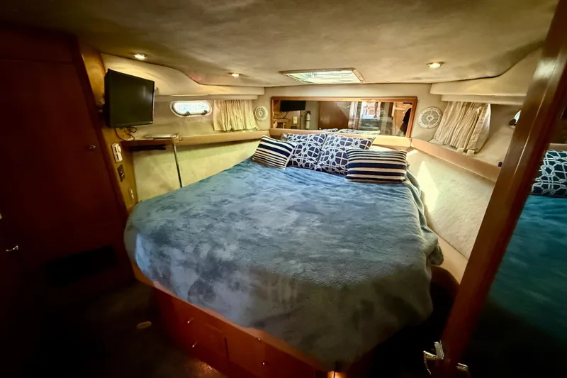 Slide: The Image of 1998 Bayliner 3988 Command Bridge Motoryacht interior with cozy seating and wooden table. - 31