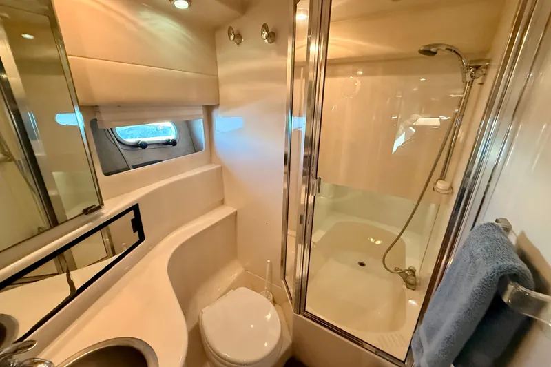 Slide: The Image of Luxurious bedroom in 1998 Bayliner 3988 Command Bridge Motoryacht with cozy bedding and ambient lighting. - 33