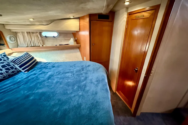 Slide: The Image of 1998 Bayliner 3988 Command Bridge Motoryacht cabin with bed and ensuite bathroom. - 37