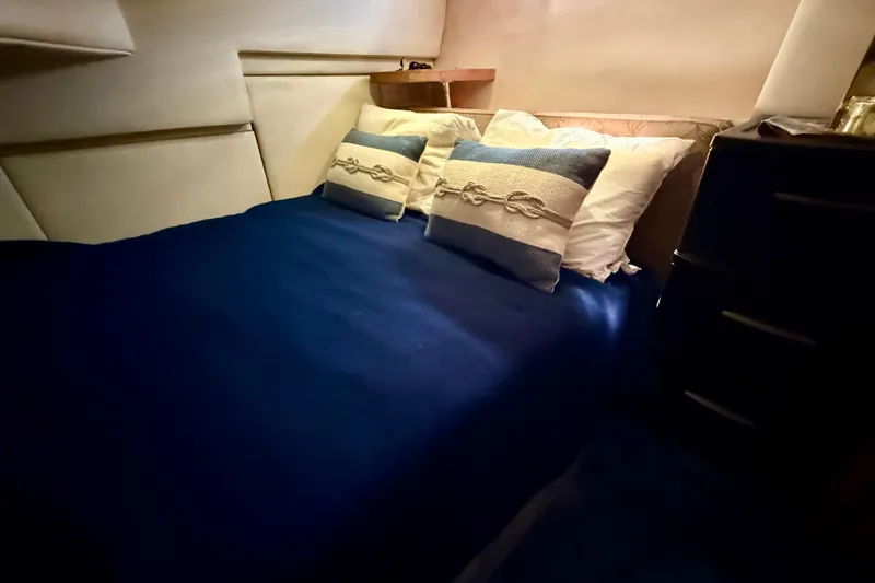 Slide: The Image of Cozy bedroom in 1998 Bayliner 3988 Command Bridge Motoryacht with nautical-themed decor. - 38
