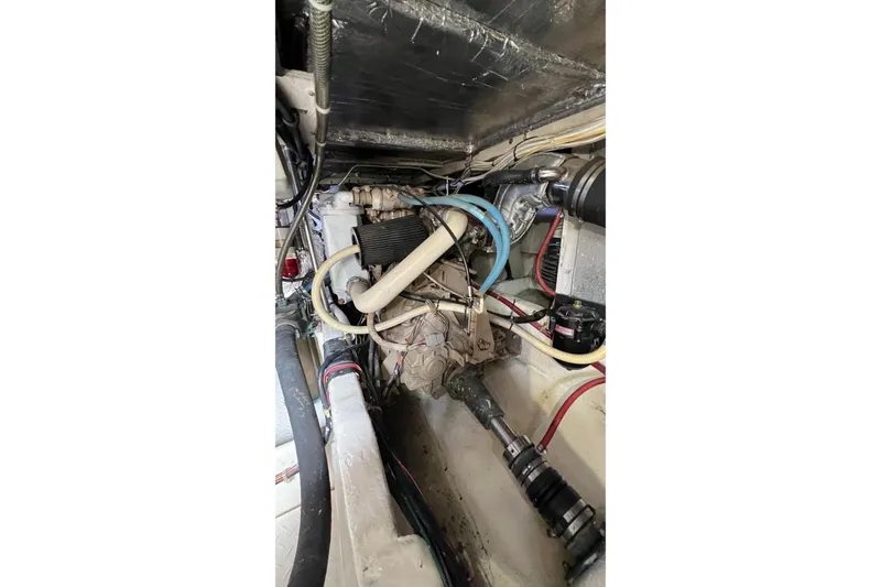 Slide: The Image of Engine compartment of 1998 Bayliner 3988 Command Bridge Motoryacht, showcasing mechanical components and wiring. - 55