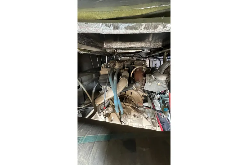 Slide: The Image of Engine compartment of a 1998 Bayliner 3988 Command Bridge Motoryacht, showcasing mechanical components. - 57