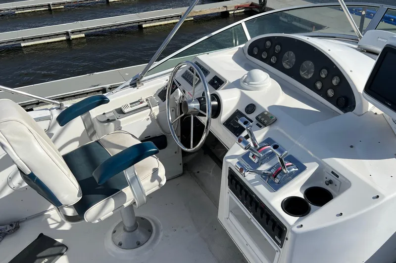 Slide: The Image of 1998 Bayliner 3988 Command Bridge Motoryacht on calm water under clear blue sky. - 7