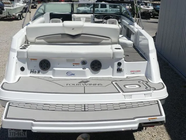 Slide: The Image of Rear view of a 2021 Four Winns HD3 boat at the dock. - 23