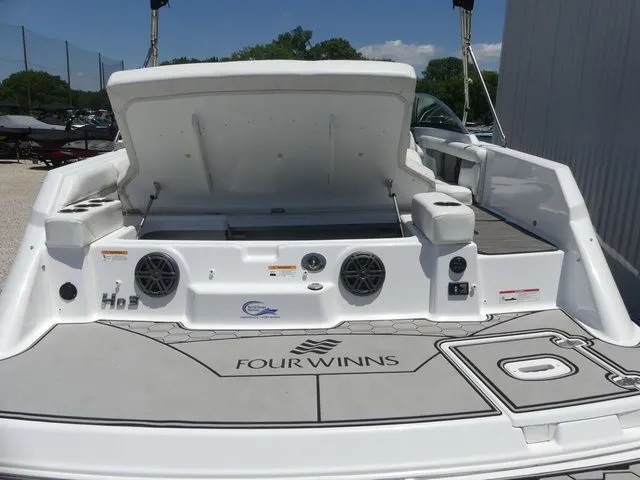 Slide: The Image of Rear view of a 2021 Four Winns HD3 boat with open storage. - 38