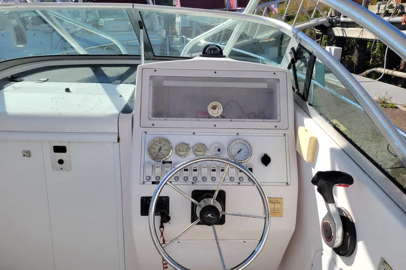 Slide: The Image of 2004 Pro-Line 23 Walk boat dashboard with steering wheel and gauges. - 10