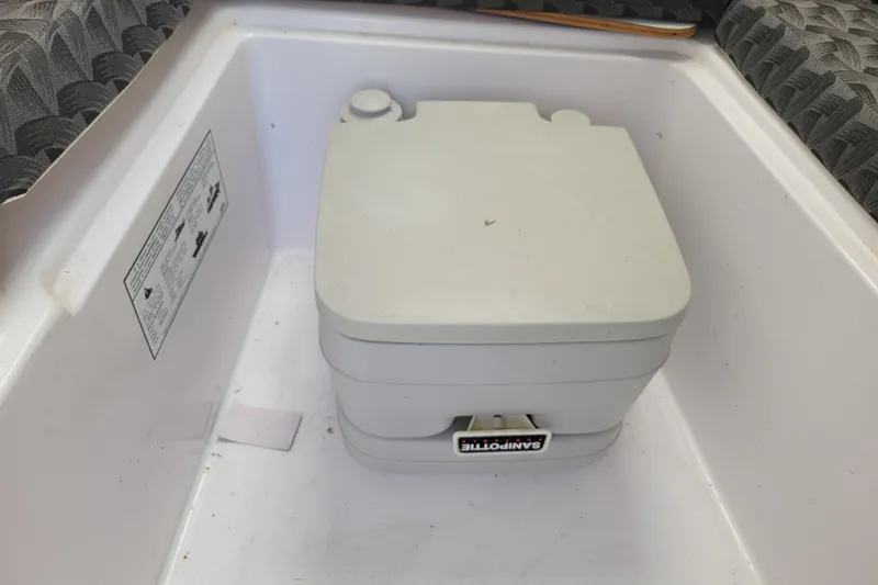 Slide: The Image of Portable toilet in a 2004 Pro-Line 23 Walk boat interior. - 15