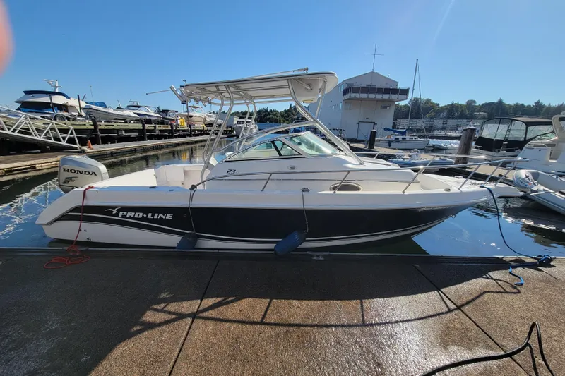 Slide: The Image of 2004 Pro-Line 23 Walk boat docked with Honda outboard motor. - 3