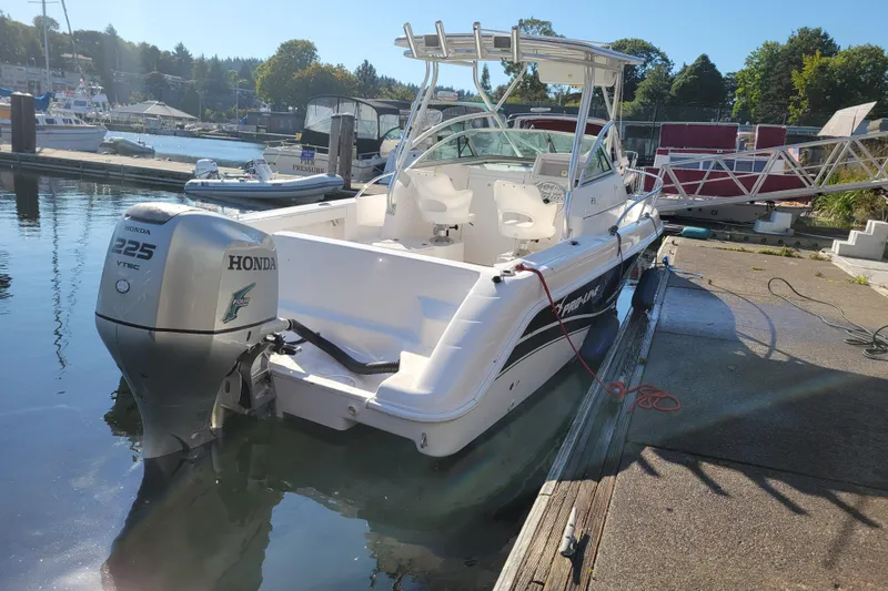 Slide: The Image of 2004 Pro-Line 23 Walk boat docked with Honda 225 VTEC outboard motor. - 5