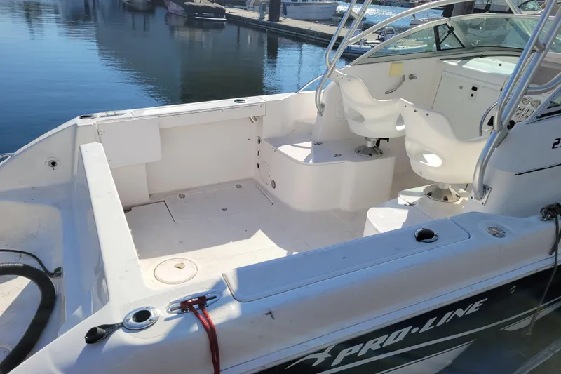 Slide: The Image of 2004 Pro-Line 23 Walk boat interior with seating, docked at marina. - 7