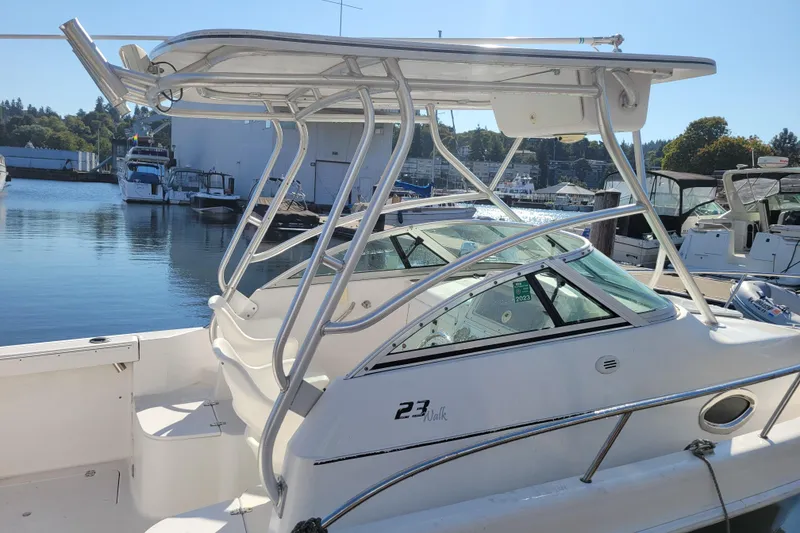 Slide: The Image of 2004 Pro-Line 23 Walk boat docked at marina, featuring sleek design and sturdy frame. - 8
