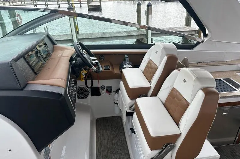 Slide: The Image of 2019 Four Winns H350 OB boat interior with dual captain seats and control panel. - 14