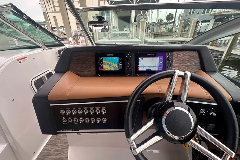 Slide: The Image of 2019 Four Winns H350 OB boat dashboard with steering wheel and navigation displays. - 15