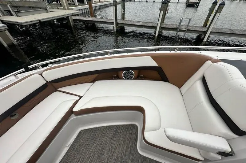 Slide: The Image of 2019 Four Winns H350 OB boat with luxurious seating at a dock. - 21