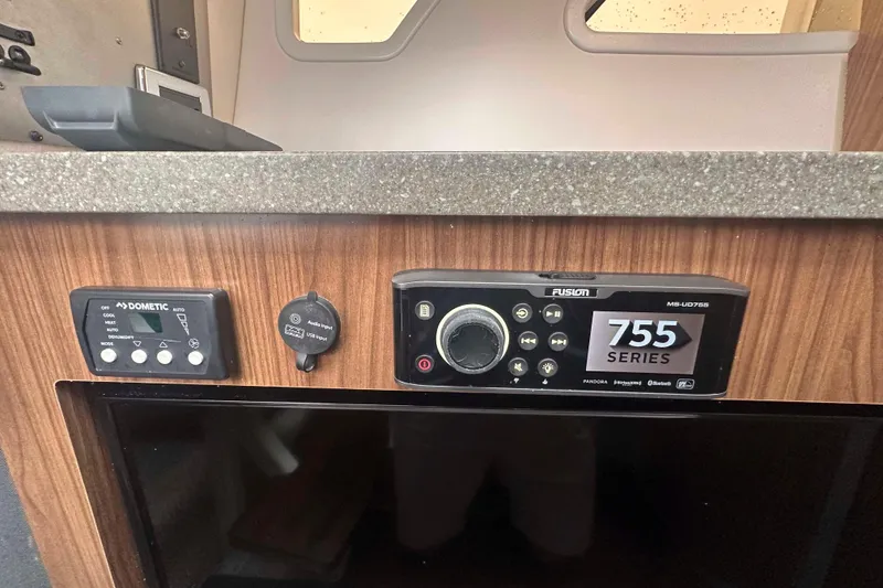 Slide: The Image of 2019 Four Winns H350 OB boat interior with Dometic control panel and Fusion 755 Series audio system. - 26