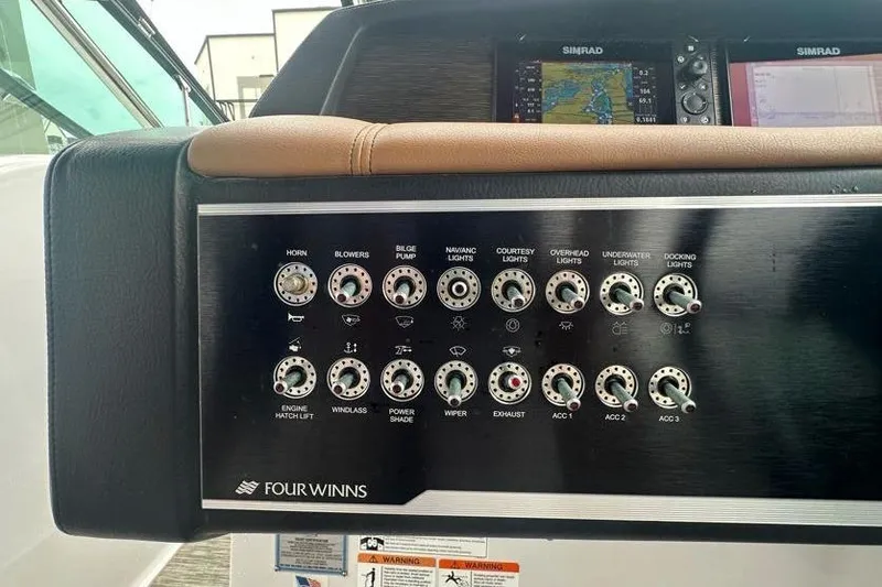 Slide: The Image of Control panel of 2019 Four Winns H350 OB boat with various switches and labels. - 27