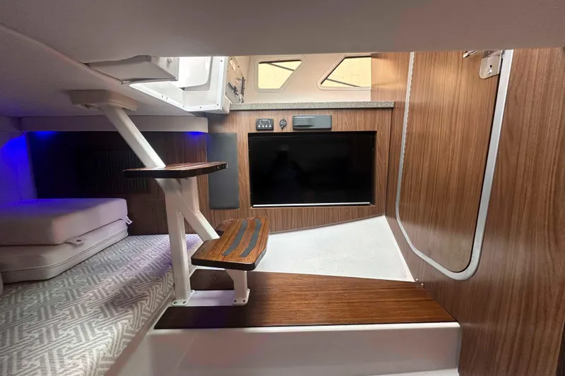 Slide: The Image of Interior of 2019 Four Winns H350 OB boat with wood accents and modern design. - 33