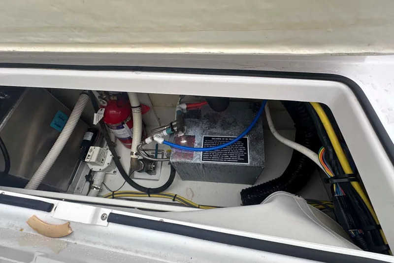 Slide: The Image of 2019 Four Winns H350 OB engine compartment with wiring and fire extinguisher. - 35