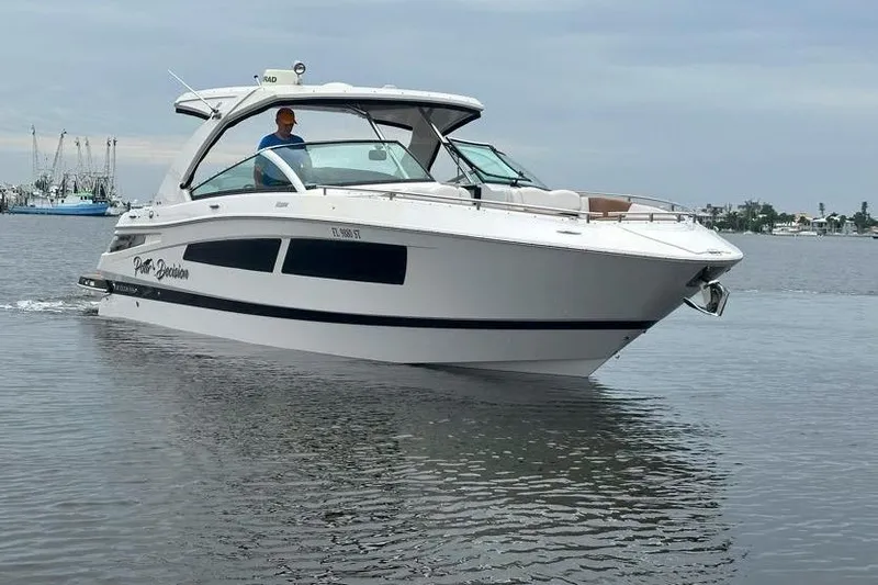 Slide: The Image of 2019 Four Winns H350 OB boat cruising on calm water. - 4