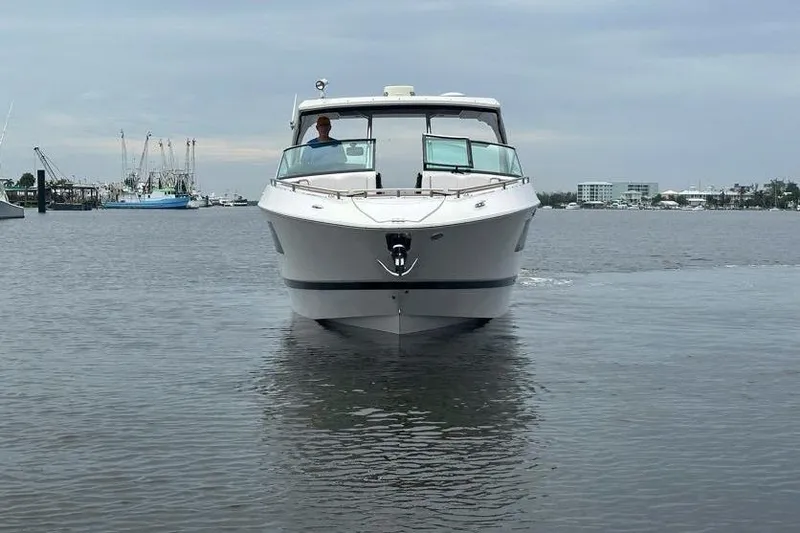 Slide: The Image of 2019 Four Winns H350 OB boat on calm water, front view. - 5