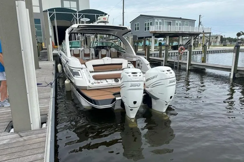 Slide: The Image of 2019 Four Winns H350 OB boat docked with twin Mercury outboard engines. - 9