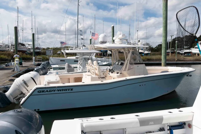 The Image of 2020 Grady-White Canyon 306 boat docked with Yamaha engines, marina background. - 0