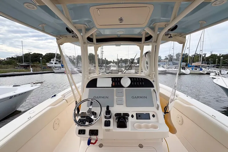 Slide: The Image of 2020 Grady-White Canyon 306 boat interior with seating and twin outboard engines at dock. - 12