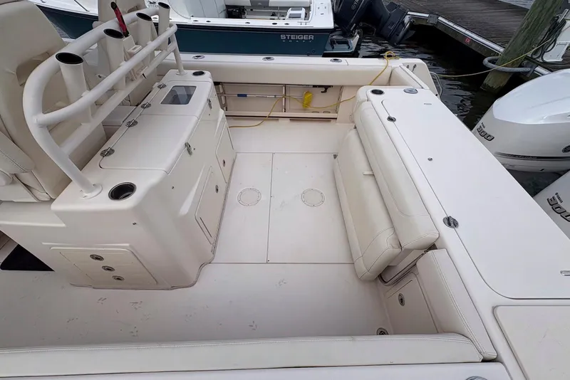 Slide: The Image of 2020 Grady-White Canyon 306 boat helm with advanced navigation controls and dual displays. - 17