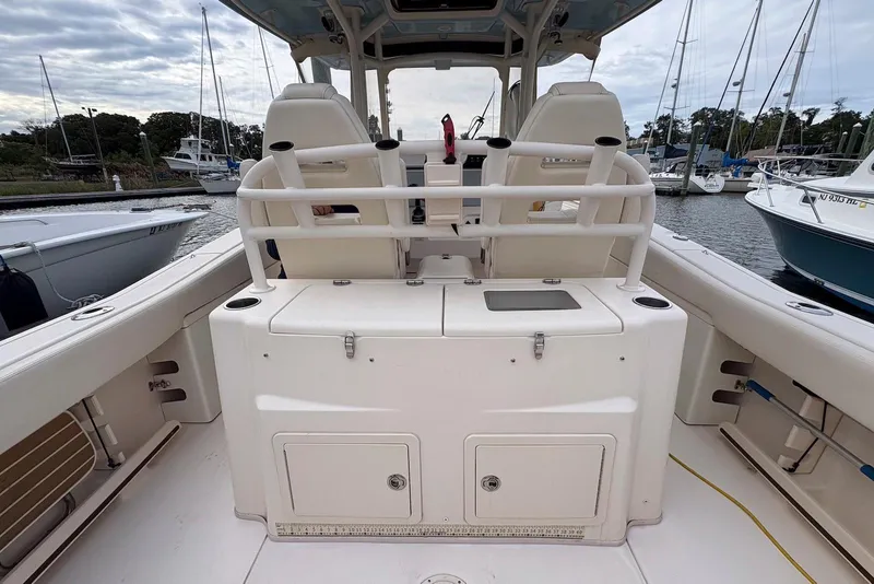 Slide: The Image of 2020 Grady-White Canyon 306 boat docked at marina under blue sky. - 18