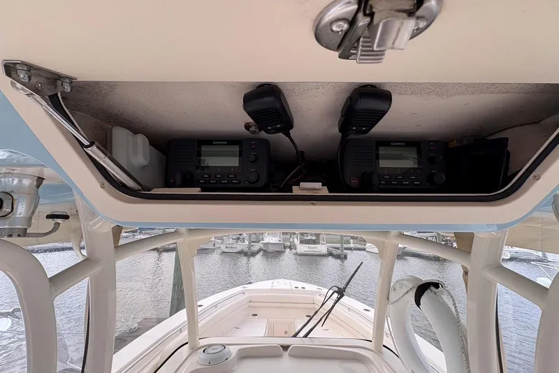 Slide: The Image of 2020 Grady-White Canyon 306 boat deck with seating, under a partly cloudy sky. - 19