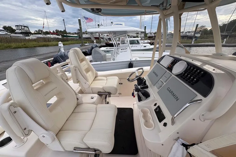 Slide: The Image of 2020 Grady-White Canyon 306 boat deck under a bright blue sky with clouds. - 20
