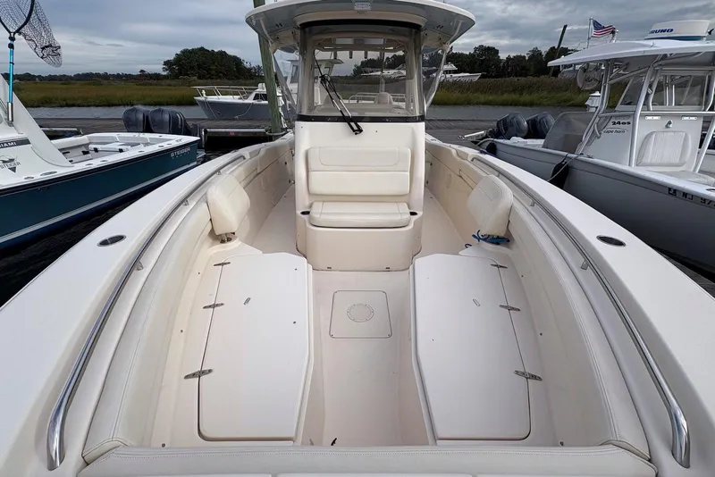 Slide: The Image of 2020 Grady-White Canyon 306 boat interior with twin Yamaha engines at dock. - 8